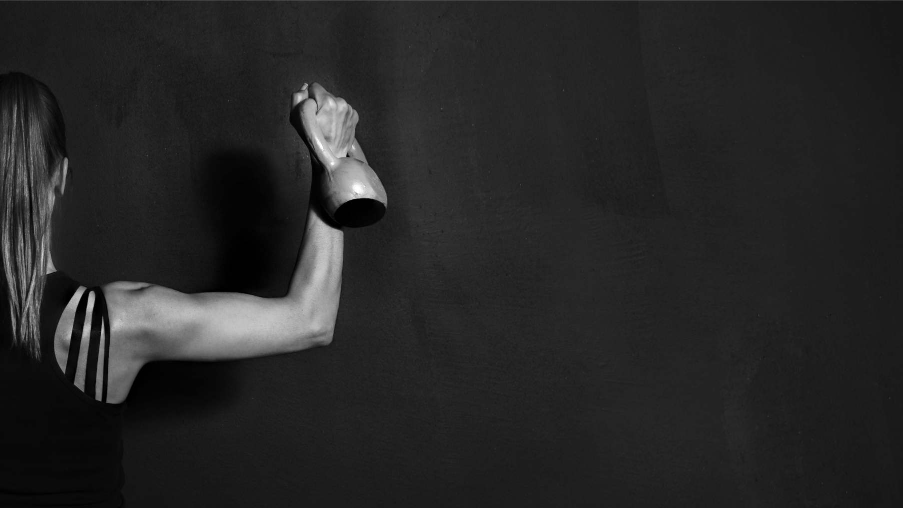 Woman strength training with kettlebell